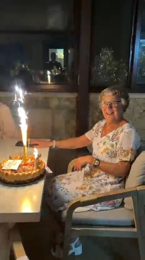The birthday guest with her personalised tiramisu celebration cake and sparklers