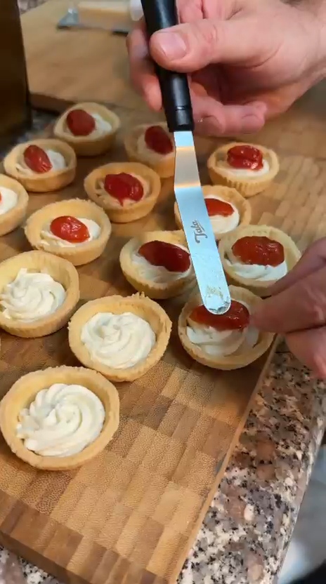 Chef Laszlo finishing whipped ricotta tartlets with confit cherry tomatoes